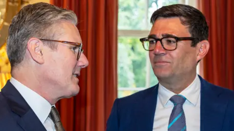 Getty Images Prime Minister Sir Keir Starmer and Greater Manchester Mayor Andy Burnham speaking at an event.