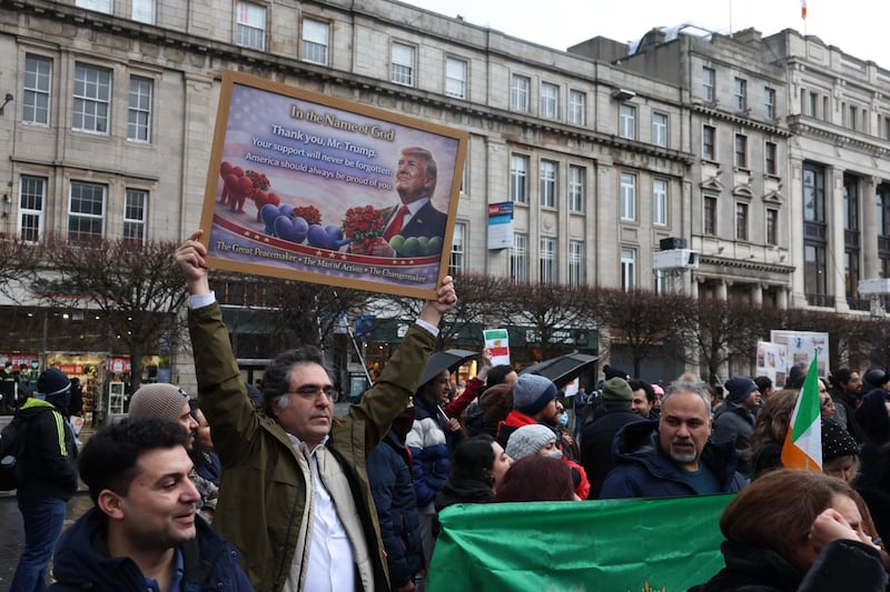 Hadi Daraei holds a pro-Trump poster he created. Photograph: Enda O’Dowd
