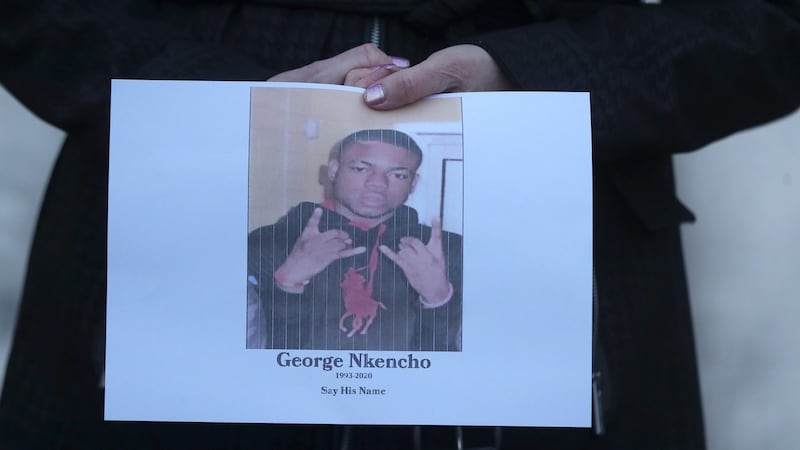 A supporter holds a photo of George Nkencho at a vigil in 2020. Photograph: Niall Carson/PA Wire