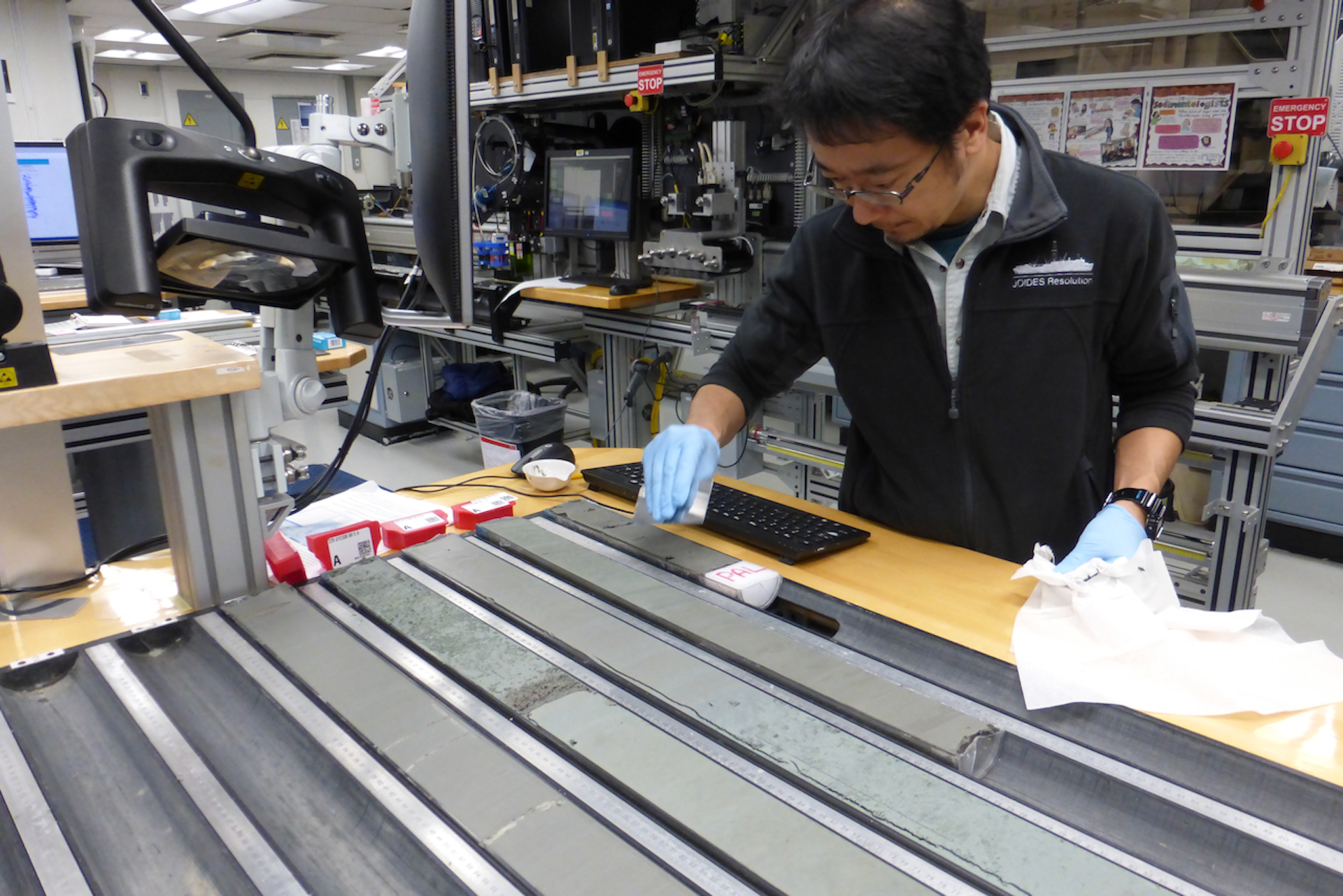 A person looks at long gray strips of rock.