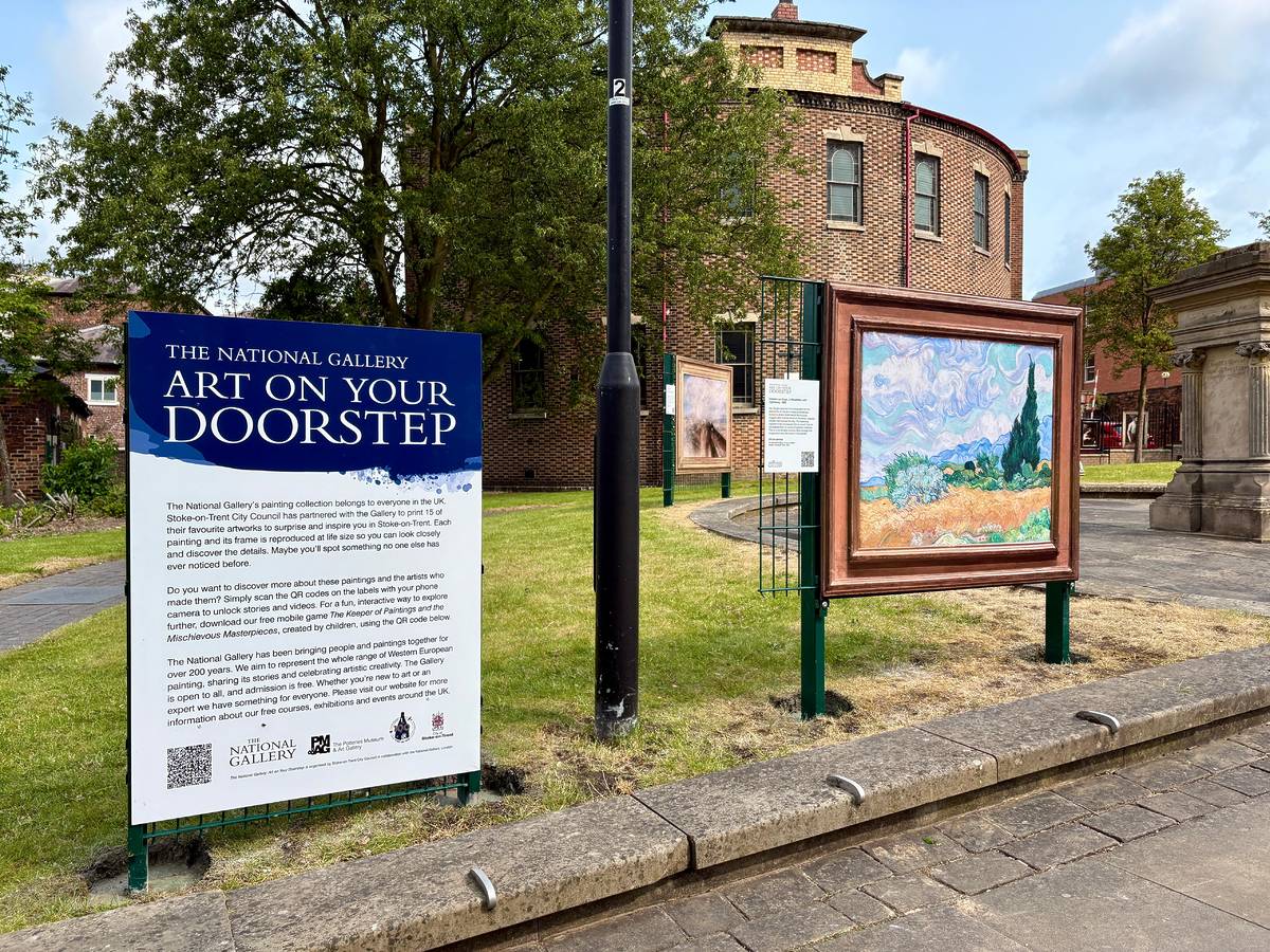 a poster about art on your doorstep next to a painting displayed in a park