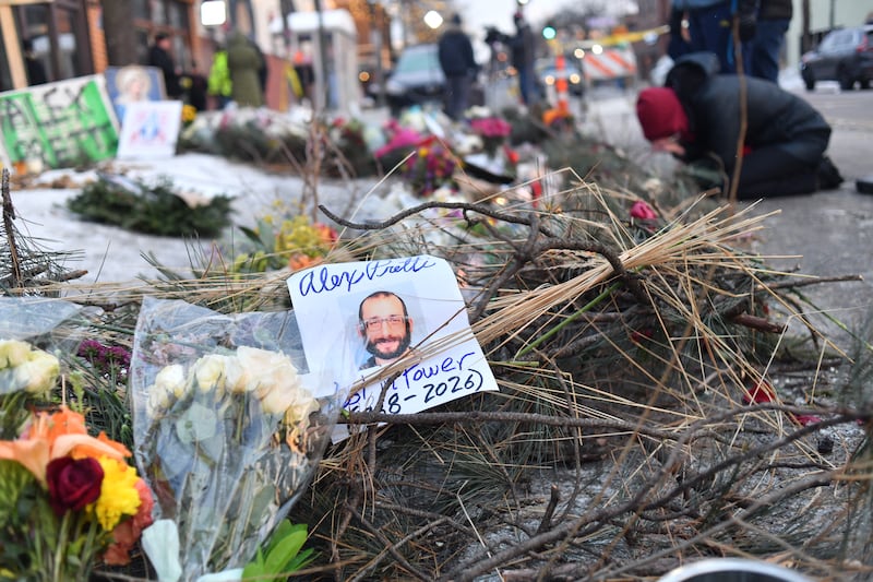 Mourners gather at a makeshift memorial in the area where Alex Pretti was shot dead a day earlier by federal immigration agents in Minneapolis, Minnesota, on January 25, 2026. (Photo by Octavio JONES / AFP via Getty Images)
