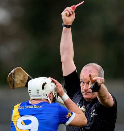 Referee Johnny Murphy shows a red card to Loughrea’s Cullen Killeen against Slaughtneil. Photograph: Ryan Byrne/Inpho