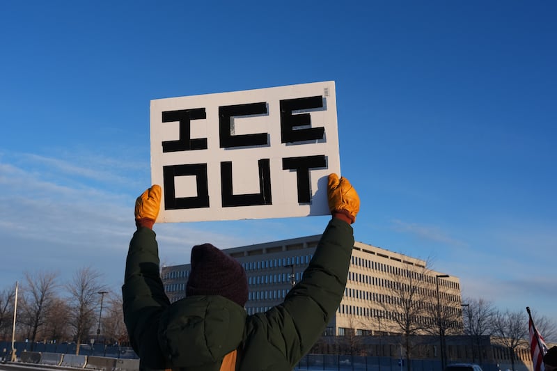 A protester holds up a sign saying ‘Ice out’ (Photo: Adam Gray/AP)