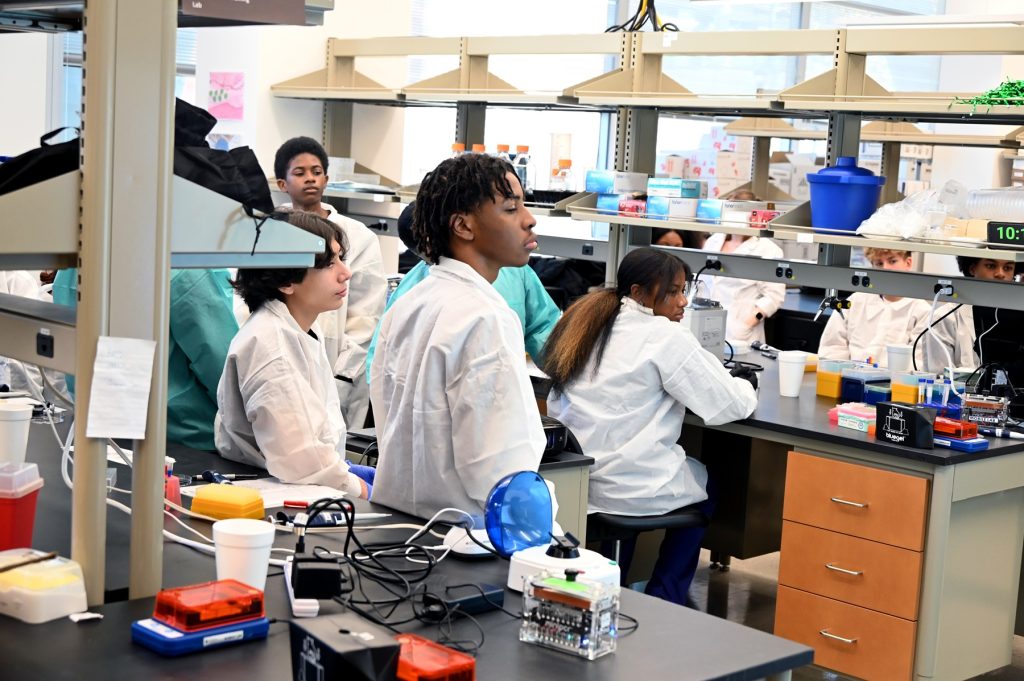In this photo, you see students standing in a research laboratory inside the Georgia Cancer Center's M. Bert Storey Research Building.
