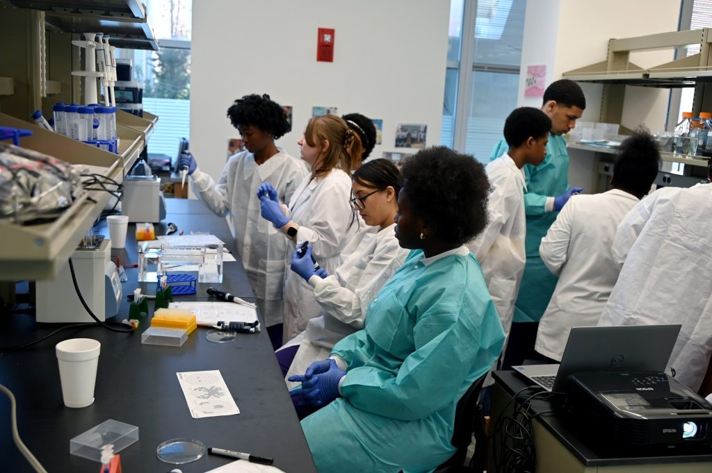 In this photo, you see students standing in a research laboratory inside the Georgia Cancer Center's M. Bert Storey Research Building.