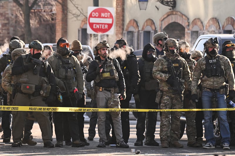 Federal agents stand behind police tape as demonstators gather near the site of where state and local authorities say a man was shot and killed by federal agents earlier on Saturday morning in Minneapolis. Photograph: Roberto Schmidt/AFP via Getty