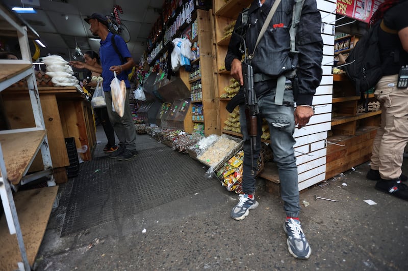 Armed supporters of ousted Venezuelan president Nicolás Maduro stand guard in Caracas. Photograph: Pedro Mattey/AFP via Getty Images