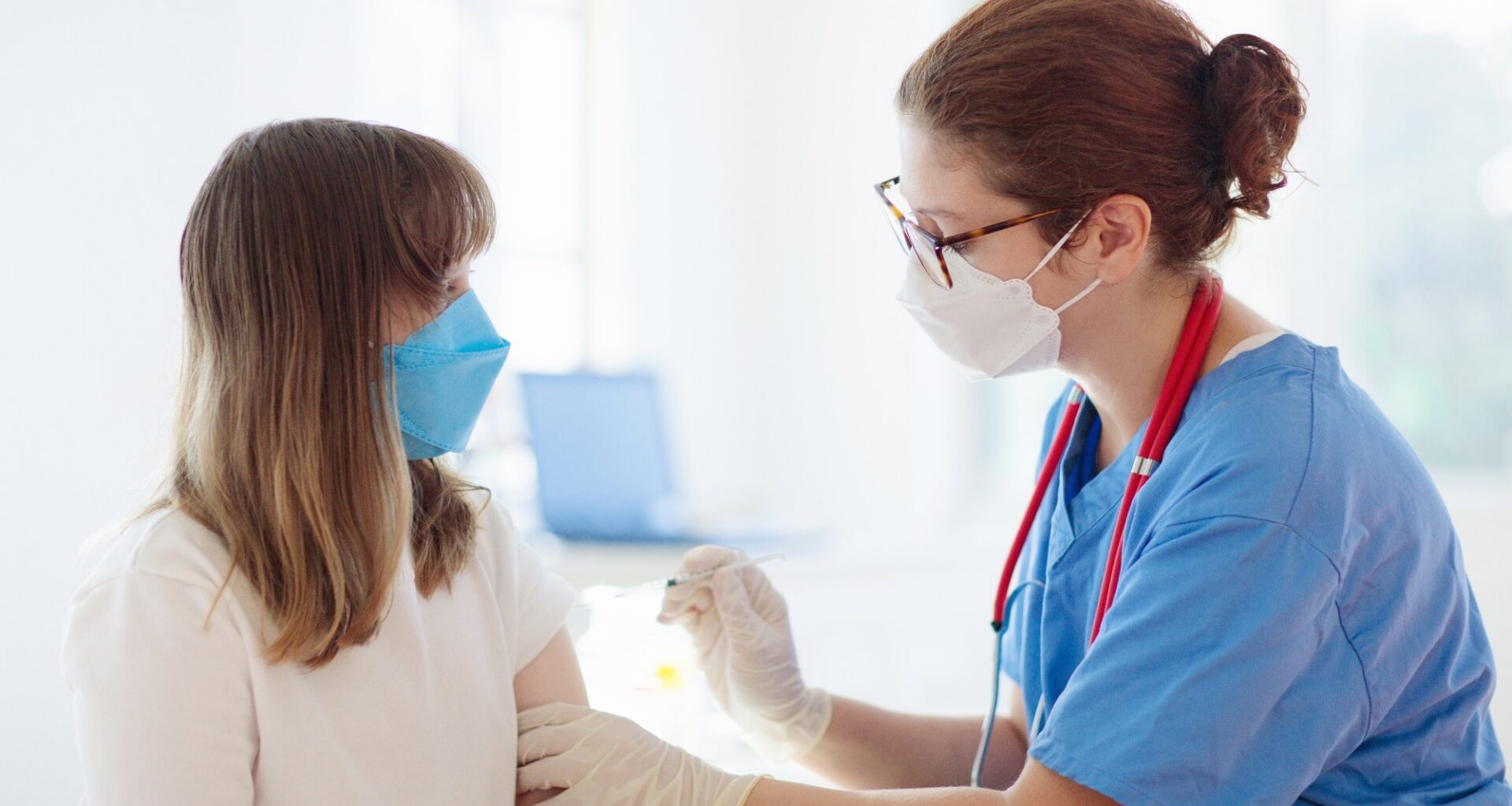 Doctor giving teen girl HPV immunization