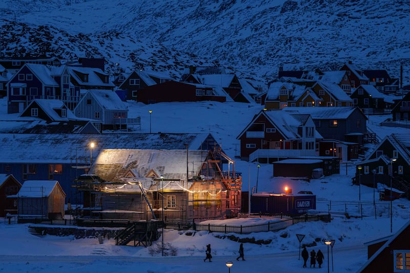 People walk along a street in Nuuk, Greenland. Photograph: Evgeniy Maloletka/AP
