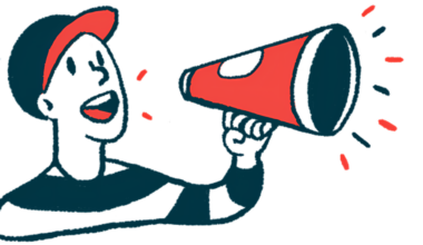 A person wearing a baseball cap speaks using a megaphone.