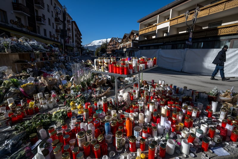 A man walks by a makeshift memorial for victims of the Constellation bar fire in Crans-Montana on Tuesday. Photograph: Fabrice Coffrini/AFP via Getty