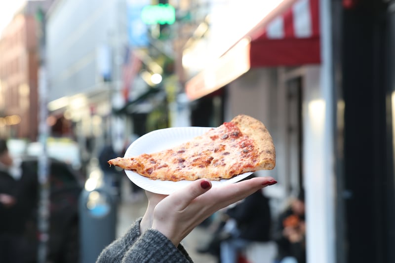 Niamh Browne shows off a slice of margherita pizza from Bambino. Photograph: Enda O'Dowd