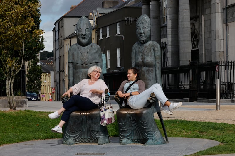 Lana Elez and Dordana Gojic from Serbia take a seat on the Marriage of Strongbow and Aoife bronze sculptures beside the Bishop's Palace  in the Viking Triangle of Waterford City.
Photograph: Alan Betson
