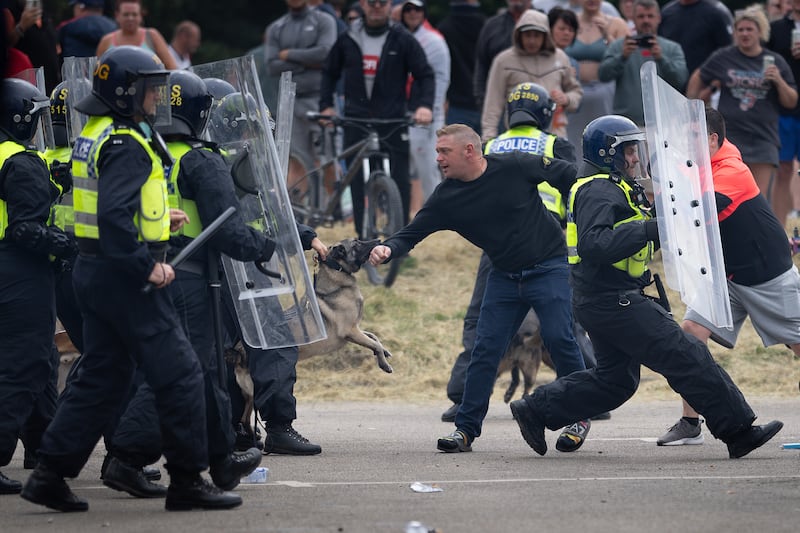 Riot police officers push back anti-immigration protesters outside a hotel housing asylum seekers in 2024. Photograph: Christopher Furlong/Getty Images