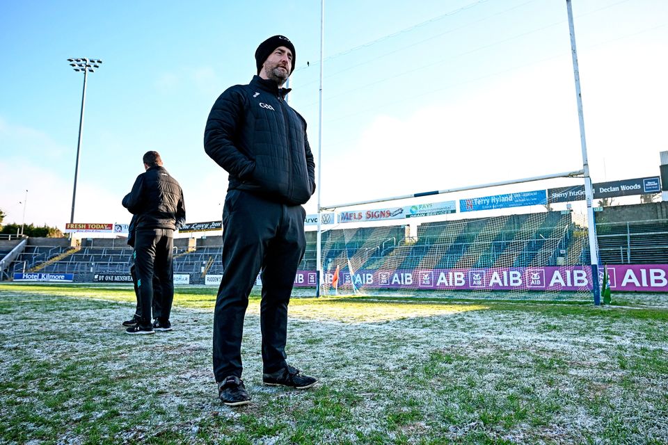 Referee Brendan Cawley inspects the pitch conditions at Kingspan Breffni Park. Photo: Seb Daly/Sportsfile