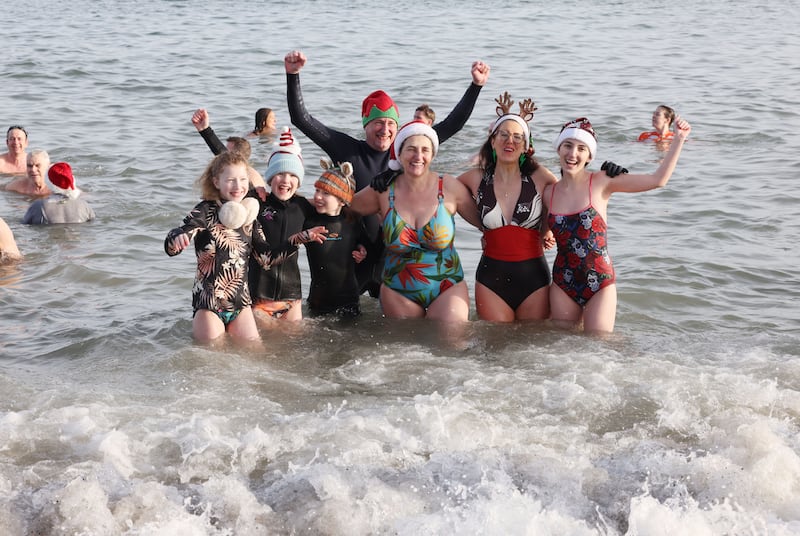 Members of the Fagan Charters, Hardy, Warner and Aryan families taking part in the Bray Lions Club New Year’s Day charity fundraising sea swim. Photograph: Alan Betson

