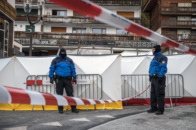 Police stand guard outside the sealed-off the Constellation bar in Crans-Montana, Switzerland, on January 2nd. Photograph: Sergey Ponomarev/The New York Times
                      
