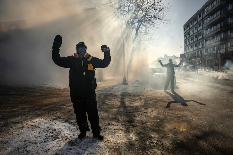 Protesters are surrounded by tear gas after confronting federal agents in Minneapolis, on Saturday, Jan. 24, 2026. (Photo by David Guttenfelder/The New York Times)