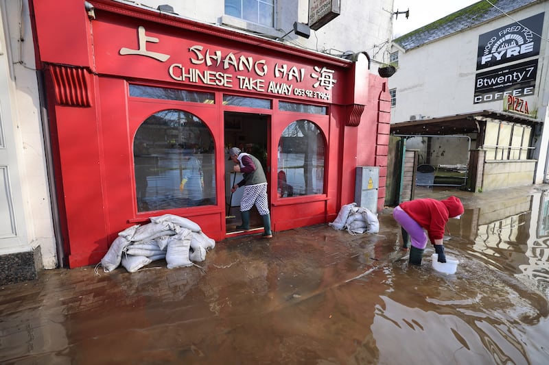 Cleaning up after Storm Chandra flood damage on Wednesday, along Shannon Quay, Enniscorthy, Co Wexford, beside the Slaney River which burst its banks.
Photograph: Dara Mac Dónaill / The Irish Times