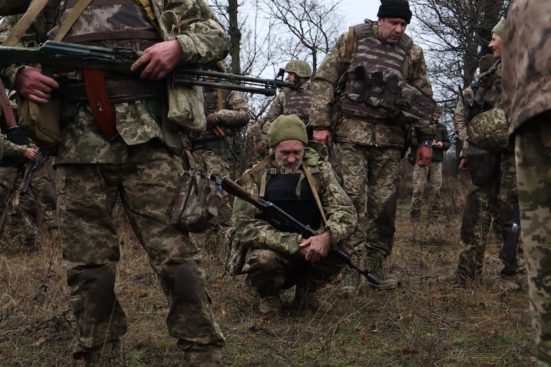 Recruits rest after drills at a training ground in the Zaporizhzhia region, Ukraine. Photograph: Andriy Andriyenko/AP
