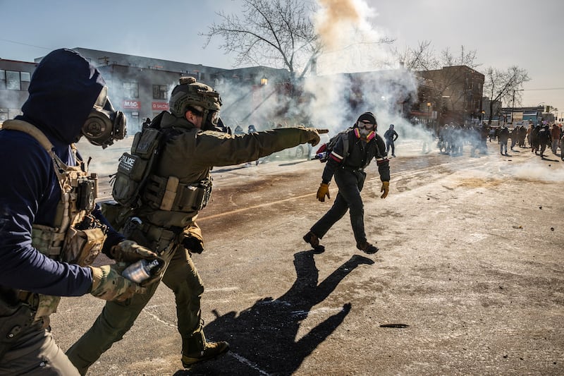 Federal agents deploy tear gas as they confront protestors in Minneapolis, near the site where federal agents shot and killed a 37-year-old Minneapolis resident, on Saturday, Jan. 24, 2026. (Photo by David Guttenfelder/The New York Times)