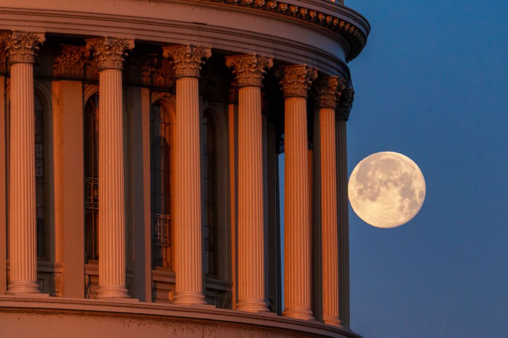 Photo of the full moon behind the pillars US Capitol Dome on February 25, 2024, in Washington, DC.