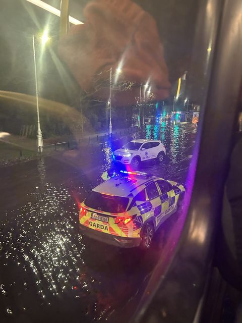 Commuters take photos of flooding in Fairview on Thursday morning