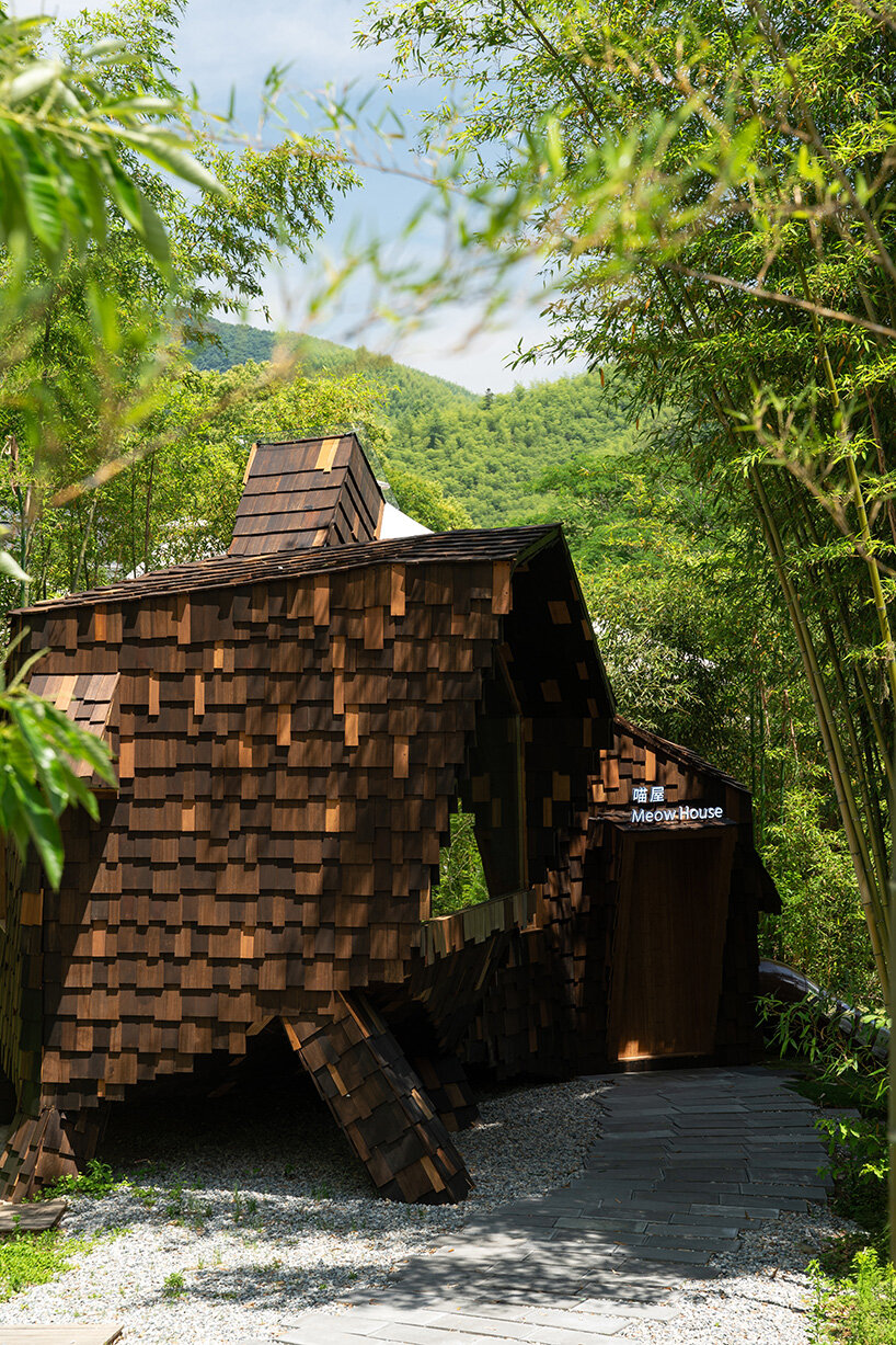 patchwork exterior of 'cat house' in china's anji forest is clad in discarded bamboo tiles