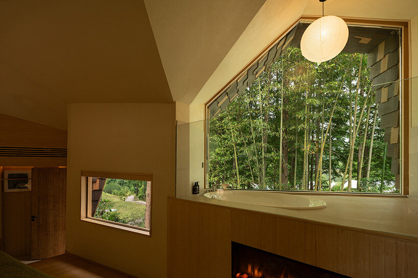 patchwork exterior of 'cat house' in china's anji forest is clad in discarded bamboo tiles