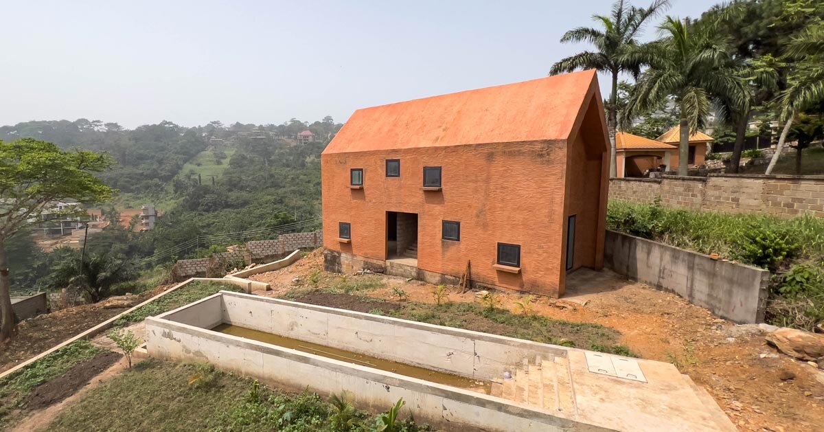 clay monolithic villas emerge from ghana’s red earth landscape