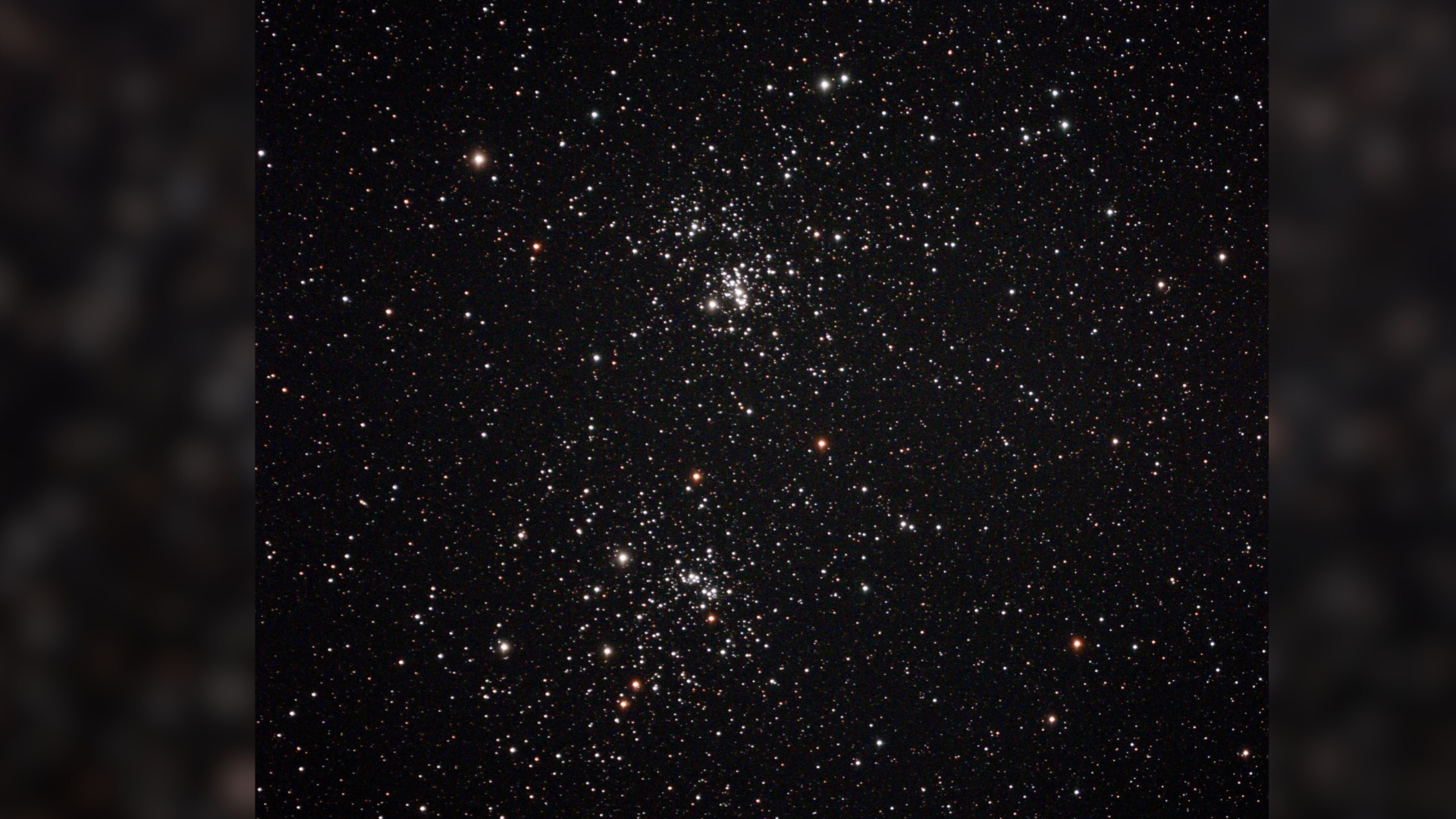 A series of bright white lights for the Perseus star cluster against a dark space background