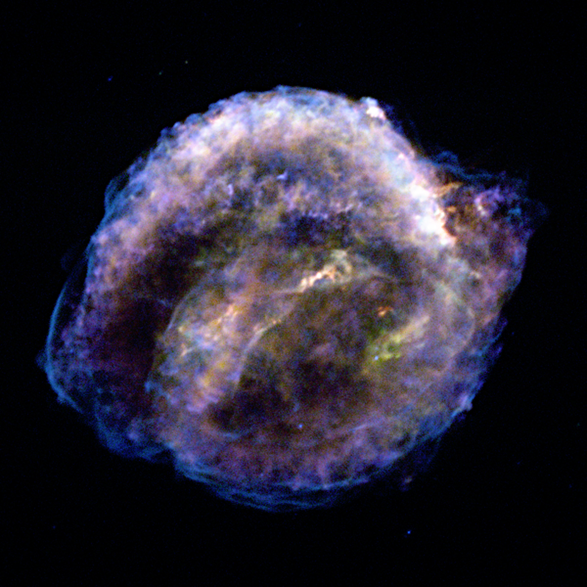 A colorful nebula-like structure against a black background, showing wispy, cloud-like patterns of blue, purple, and yellow light—captured by NASA Chandra as Kepler's supernova remnants expand over 25 years.