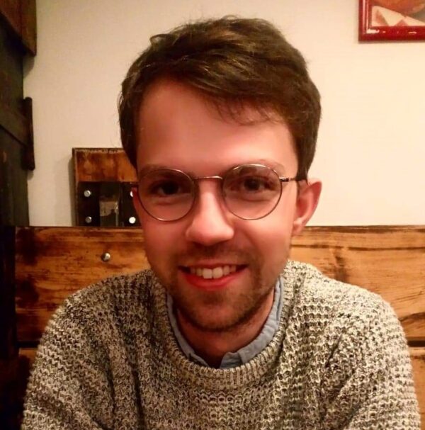 Young smiling man in glasses.