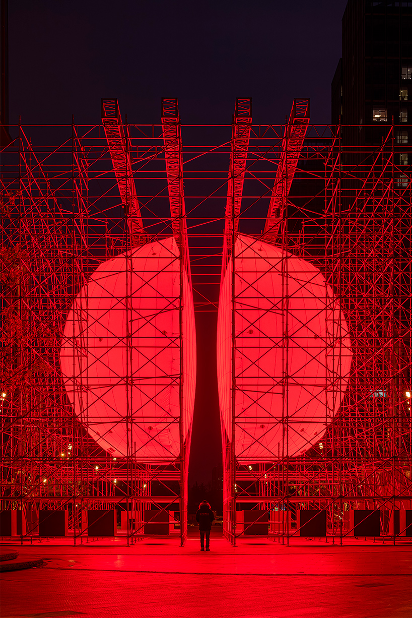 SpY's monumental divided sphere installation illuminates xi’an in bright red light