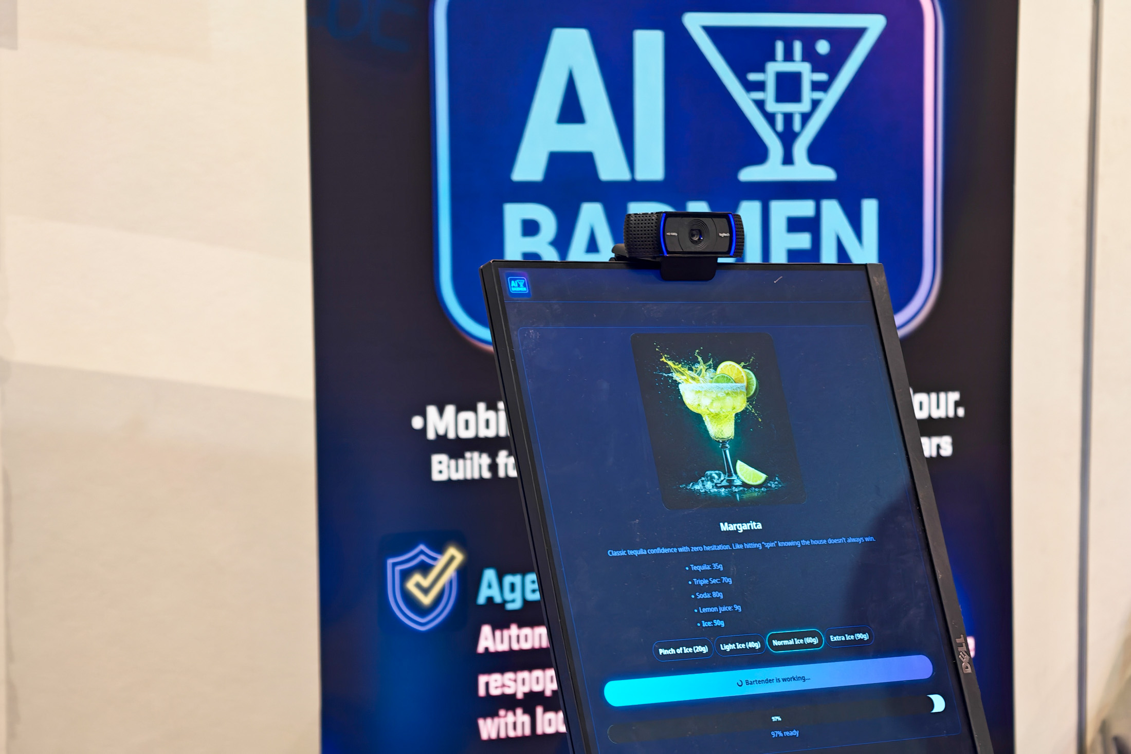 A vertical monitor displaying an image of a margarita. There is a webcam mounted on top.