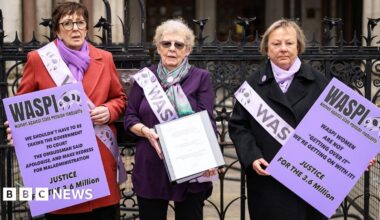 Three Waspi campaigners with purple placards outsdie the Royal courts of Justic