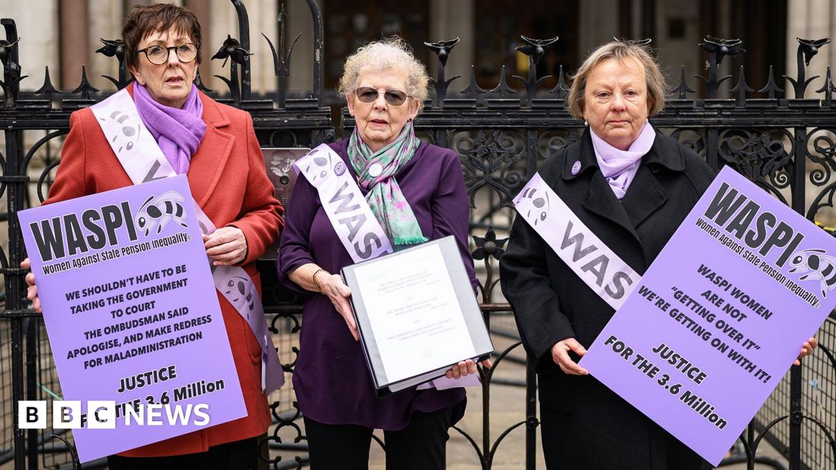 Three Waspi campaigners with purple placards outsdie the Royal courts of Justic