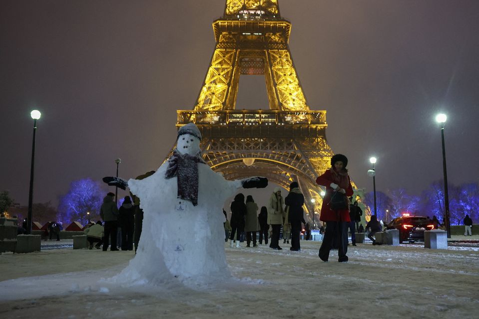 A snowman at the Eiffel Tower in Paris. Photo: Reuters/Gonzalo Fuentes.