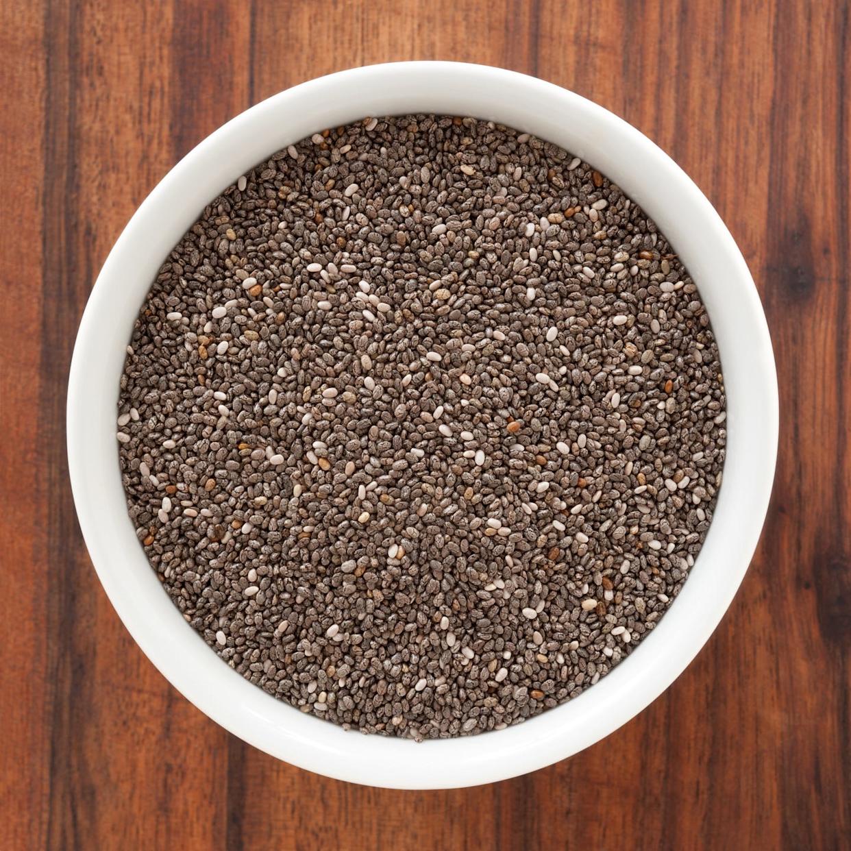 white bowl of chia seeds on a wooden table