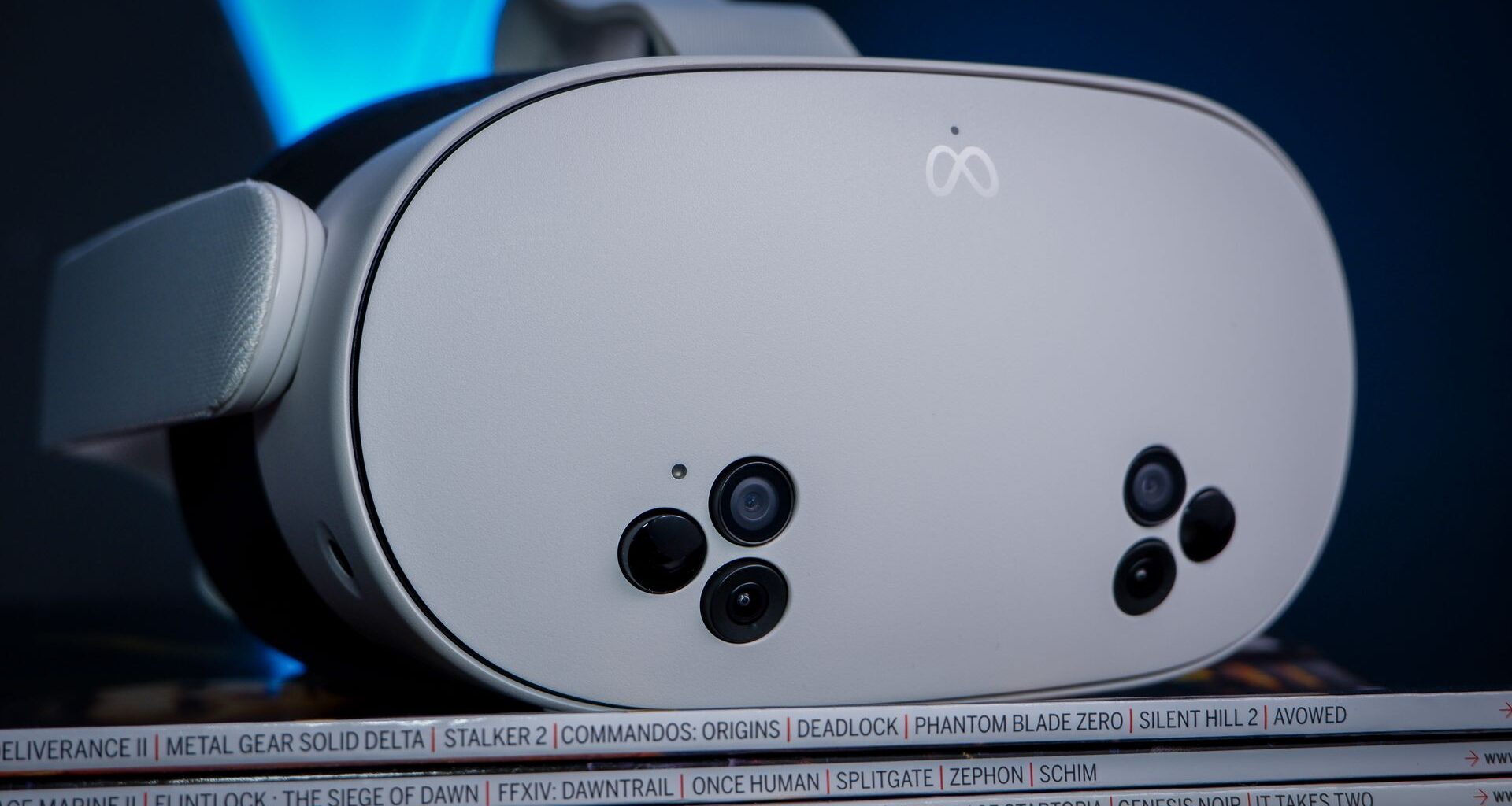 A Meta Quest 3S, alongside a Quest 3 and Quest 2, on a stack of PC Gamer magazine.