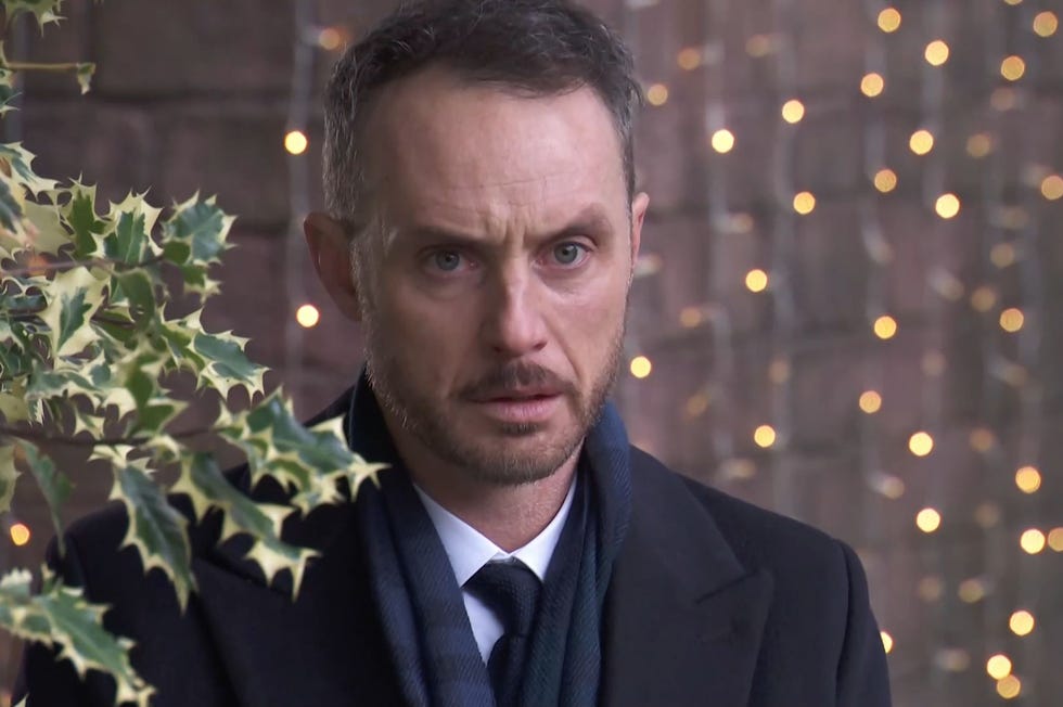 Hollyoaks James Nightingale hollyoaks james nightingale outside in the village wearing a scarf with holly leaves to his right