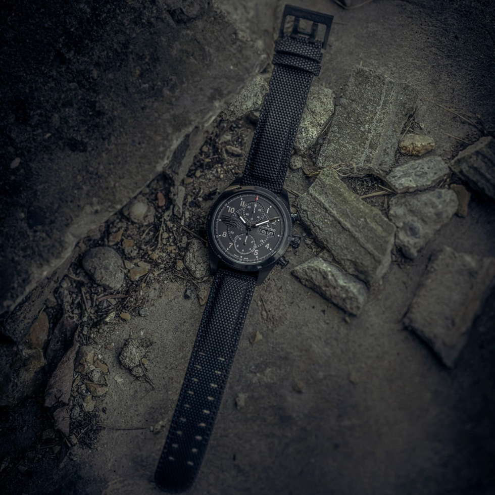 black textured wristwatch on a rough surface