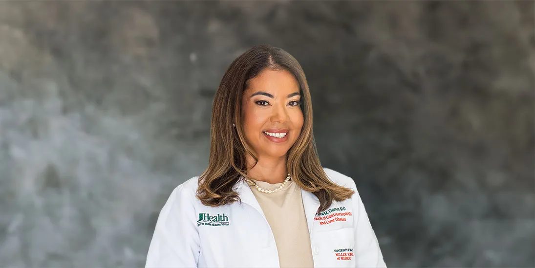 Dr. Oriana Damas, smiling in her white clinic coat