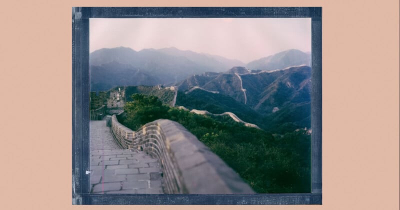 A Polaroid-style photo of the Great Wall of China winding over green hills and mountains under a hazy sky, with stone pathways and bricks visible in the foreground.