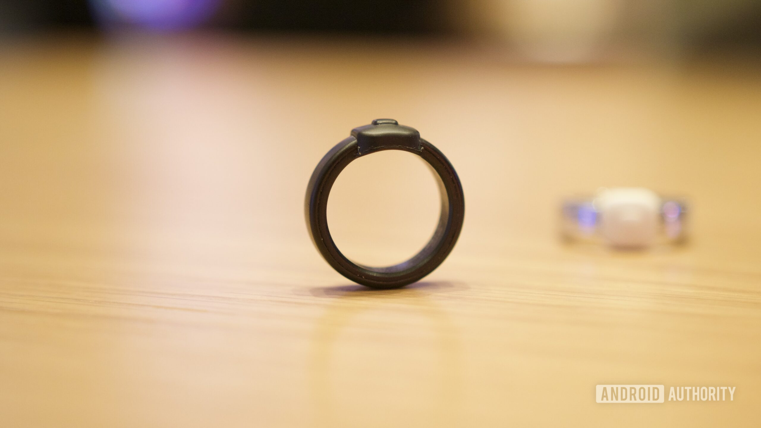 Pebble Index 01 ring sitting upright on a table.