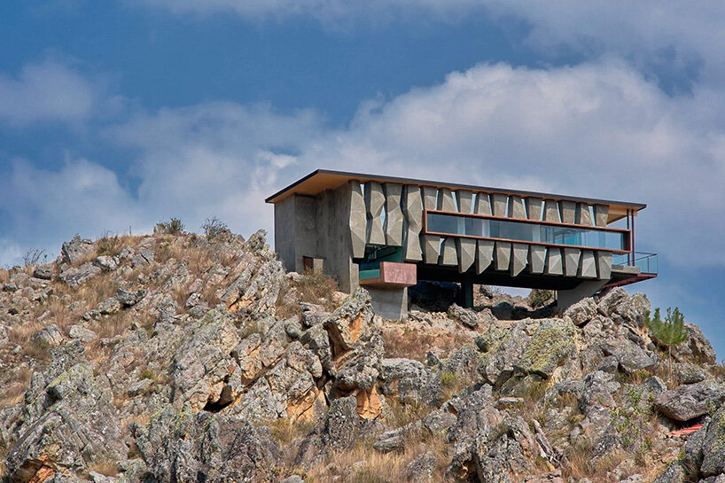 reflective glass surfaces mirror the rocky terrain across andean cabin by rtresarquitectos