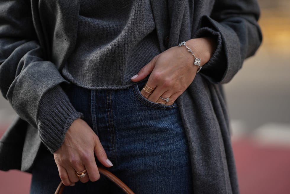 duesseldorf, germany november 10: patricia wirschke is seen wearing a gray wool jacket with front pockets by lisa yang; grey cashmere sweater by lisa yang; straight leg blue denim in a slim cut by levi’s; a structured camel brown leather “kelly 32” handbag with gold hardware and top handles by hermès; her jewelry includes a rose gold “serpenti” ring by bulgari; a rose gold “b.zero1” ring by bulgari; and a white gold “alhambra” bracelet by van cleef arpels on november 10, 2025 in duesseldorf, germany. (photo by moritz scholz/getty images)