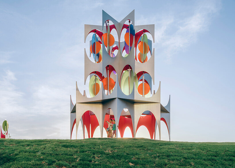 suspended colored discs move through daxing jizi design's faceted installation in beijing