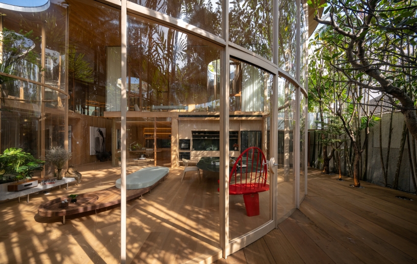 curved glass atriums penetrate residence’s aluminum roof in bangkok